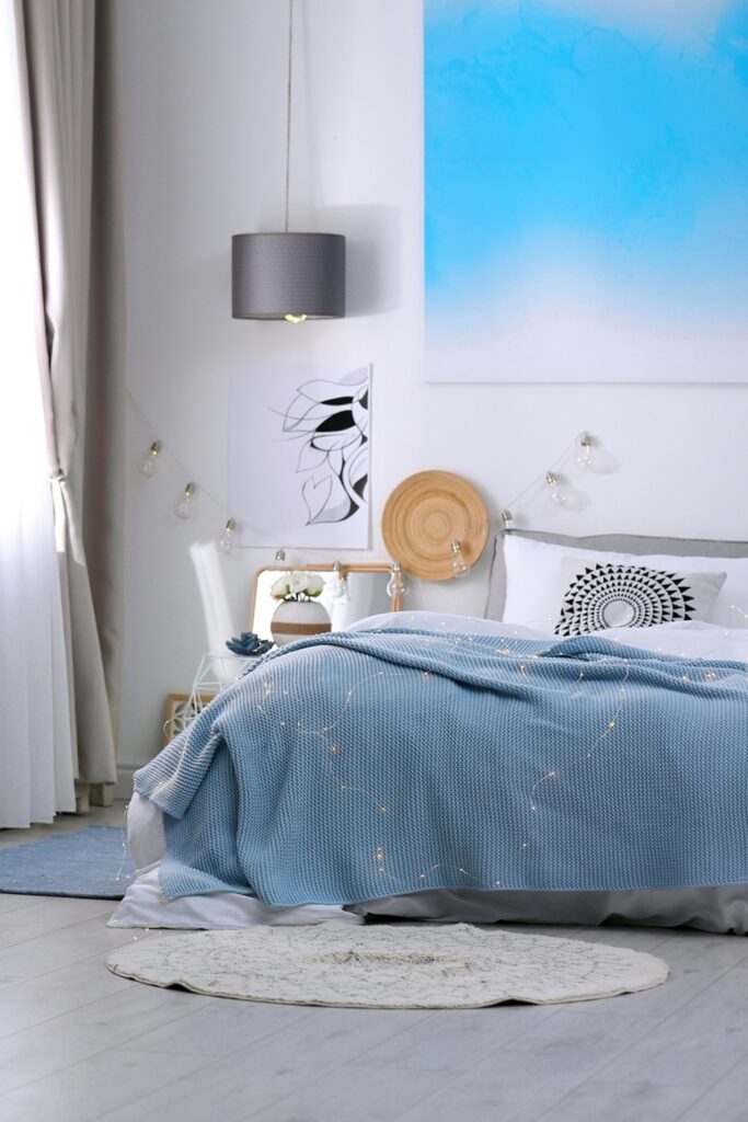 Stylish room interior with comfortable bed